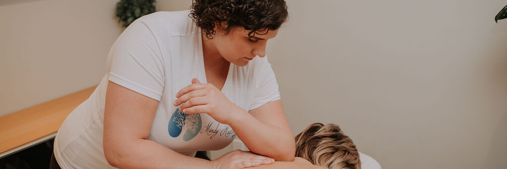 Mindy giving a woman a massage